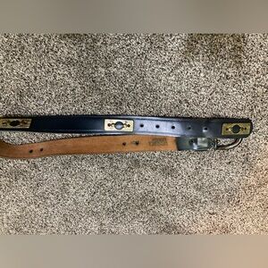 Leather belt with brass accents and buckle